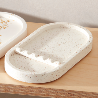 Speckled ceramic dish on a wooden surface