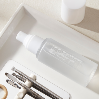 Brow grooming kit with a spray bottle labeled 'London Brow Company' on a neutral background.