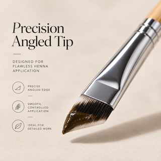 A close-up of a flat makeup brush with a silver metal ferrule and angled bristles, shown on a warm beige background with text describing the precision angled tip and henna application benefits.