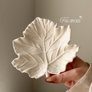 Fall Speckle leaf jesomonite tray against natural back ground being held by a ladies hand.