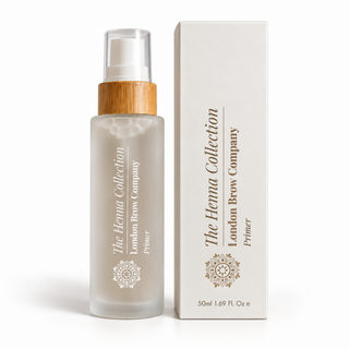 The Henna Collection London Brow Company Primer in a frosted glass bottle with a bamboo-look pump collar, shown next to its cream-colored product box on a white background.