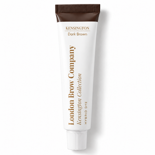 A white squeeze tube of London Brow Company Kensington Collection Hybrid Dye in Dark Brown, featuring a dark brown cap and gold lettering, set against a clean white background with a soft shadow.