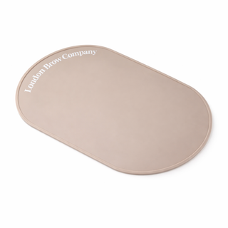 Beige oval-shaped product with 'London Brow Company' text on a white background