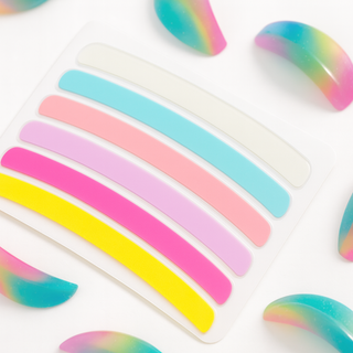 Rainbow lash lifting ribbon on a white background with rainbow lash lifting shields from the london brow company