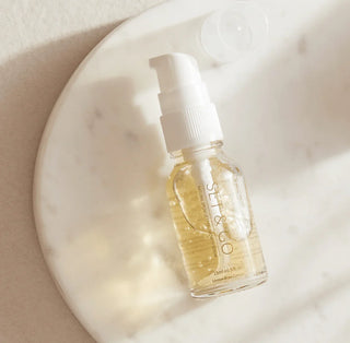 Skincare serum bottle with pump on a marble surface The London Brow Compay