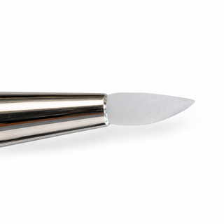 Close-up of a metallic silver cosmetic brush tip with a soft, translucent white bristle, shown against a solid white background.